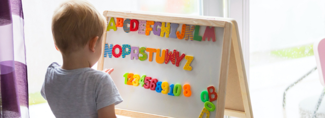 child-spelling-with-letters-on-board